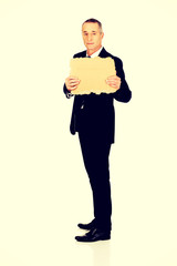 Businessman holding a piece of cardboard
