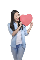 Beautiful asian girl holding red heart