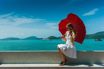 Girl with an umbrella against the sea