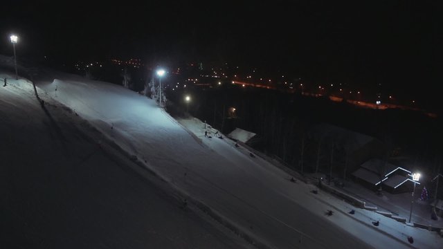 Aerial view people relax at a ski resort at night