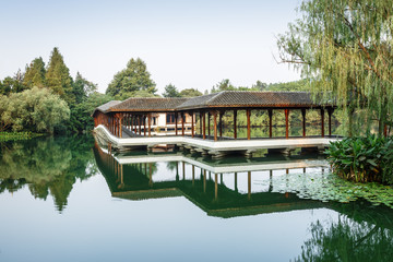 Fototapeta premium ancient traditional gallery bridge on the west lake in hangzhou,China