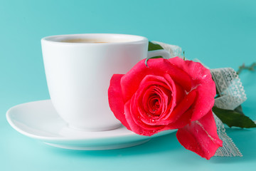 cup of coffee on the table with rose flower
