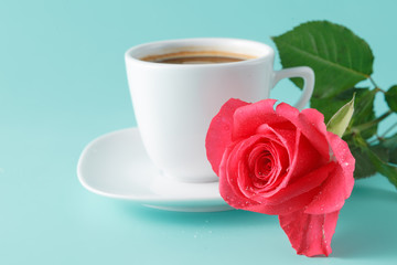 cup of coffee on the table with rose flower