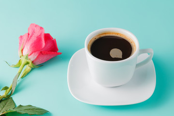 cup of coffee on the table with rose flower