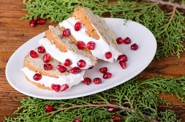 Pieces of cake decorated with icing and a pomegranate