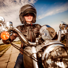 Fototapeta na wymiar Biker girl on a motorcycle