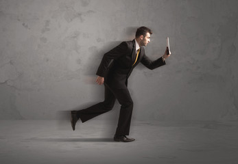 Fototapeta premium Running businessman with device in hand