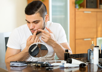 Man removes pimples