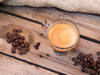 Cup of coffee on aged wooden table