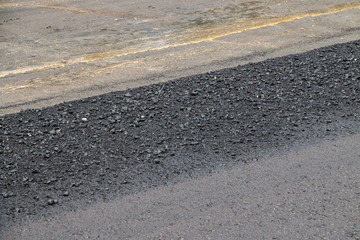 Close-up asphalt at the road under construction.