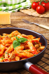 Penne with roasted chicken in tomato sauce