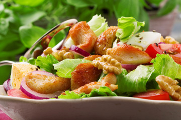 Delicious salad with chicken, nuts, egg and vegetables.