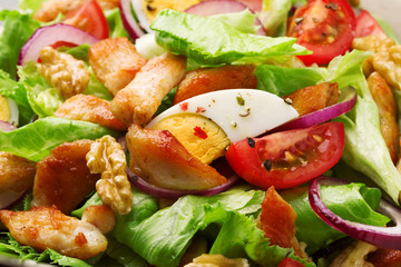 Delicious salad with chicken, nuts, egg and vegetables.