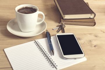 Still life photo of smartphone, notebook, coffee, book, pencil a