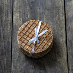 dutch waffles with caramel on wooden background