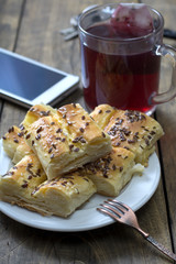 Homemade mini cheese pie on wooden background