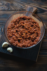 Close-up of a glass bowl with bolognese sauce, studio shot