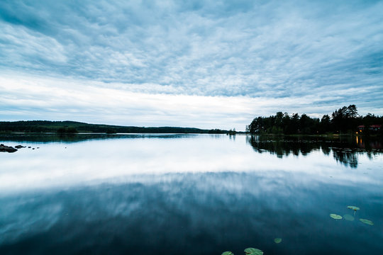 A beautiful view of a typical Swedish summer lake landscape at dusk. Location: Falun, Dalarna - Stora Vallan Lake.
