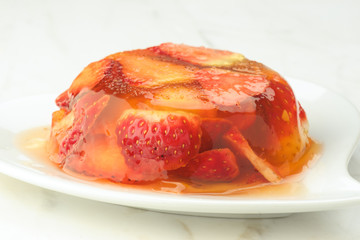 gelatin dessert and fresh strawberries on white marble