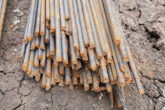 Stack of rusty round steel bar - iron metal rail lines material