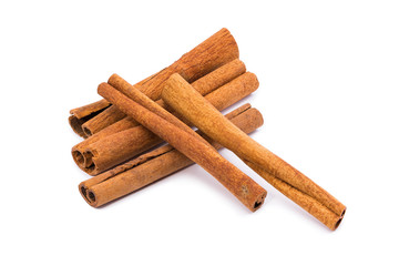 Five Sticks Of Cinnamon On A White Background