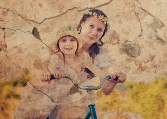 Mom and daughter on a bicycle.