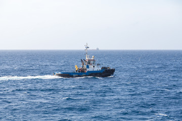 Blue Tugboat at Sea