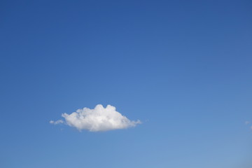 Cloud against clear blue sky background