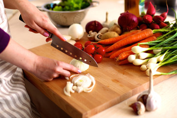 Young Woman Cooking in the kitchen. Healthy Food
