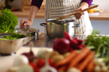 Young Woman Cooking in the kitchen. Healthy Food