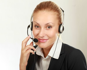 Female call center operator with headphone browsing on her computer
