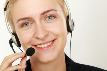 Female call center operator with headphone browsing on her computer
