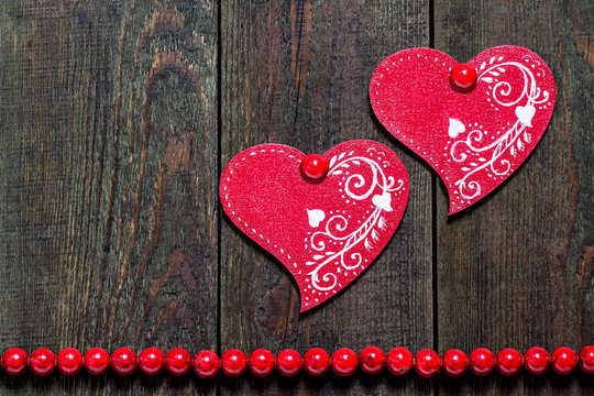 Two wooden hearts with ornament