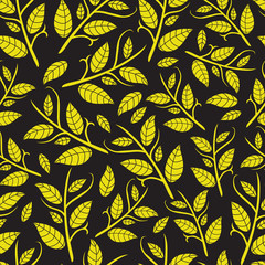 Yellow leaves on a black background. Seamless pattern.