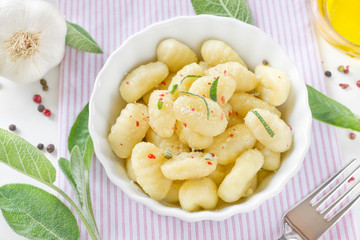 Delicious italian gnocchi with sage leaves and olive oil