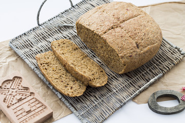 Wheat bread. Buckweat bread with dried tomatoes and thyme, on white background, basket and grey paper. 