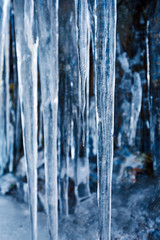 Icicles hanging on mountain rock