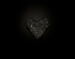 Silver heart on black background