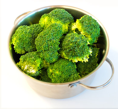 Fresh broccoli in casserole dish, isolated