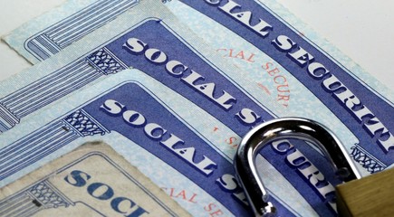 Padlock and social security card - Identity theft and identity protection concept