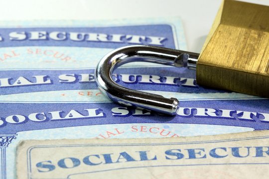 Padlock and social security card - Identity theft and identity protection concept