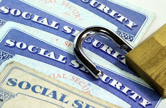 Padlock and social security card - Identity theft and identity protection concept
