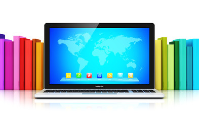 Laptop in front of row of color books