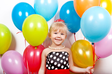 Fototapeta na wymiar Beautiful cheerful girl holding a lot of colorful balloons