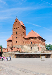 Fototapeta premium Tourists and Trakai Castle. Lithuania