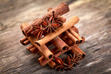 Cinnamon sticks and anice on wooden table. selected focus