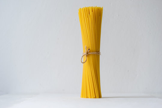 Uncooked spaghetti pasta on kitchen table. Selective focus.