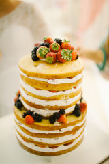 wedding cake decorated with berries and strawberries