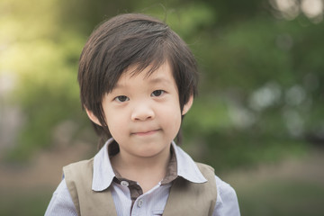 asian boy smiling and looking at camera portrait