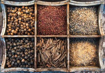 Assortment of spices and olibanum in wooden box.